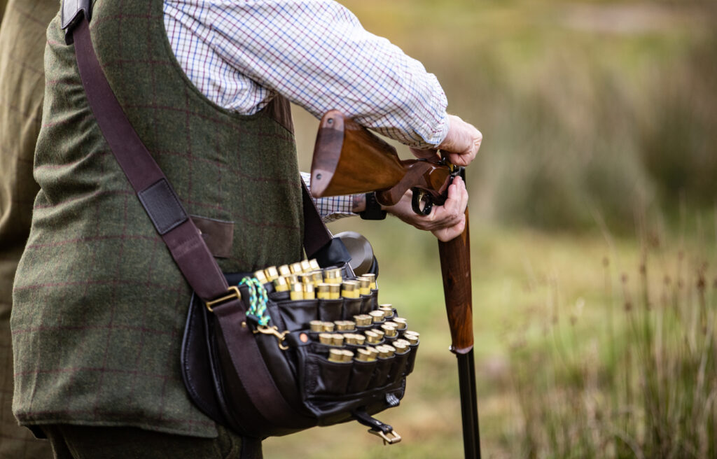 Close up of shotgun being loaded with cartridges